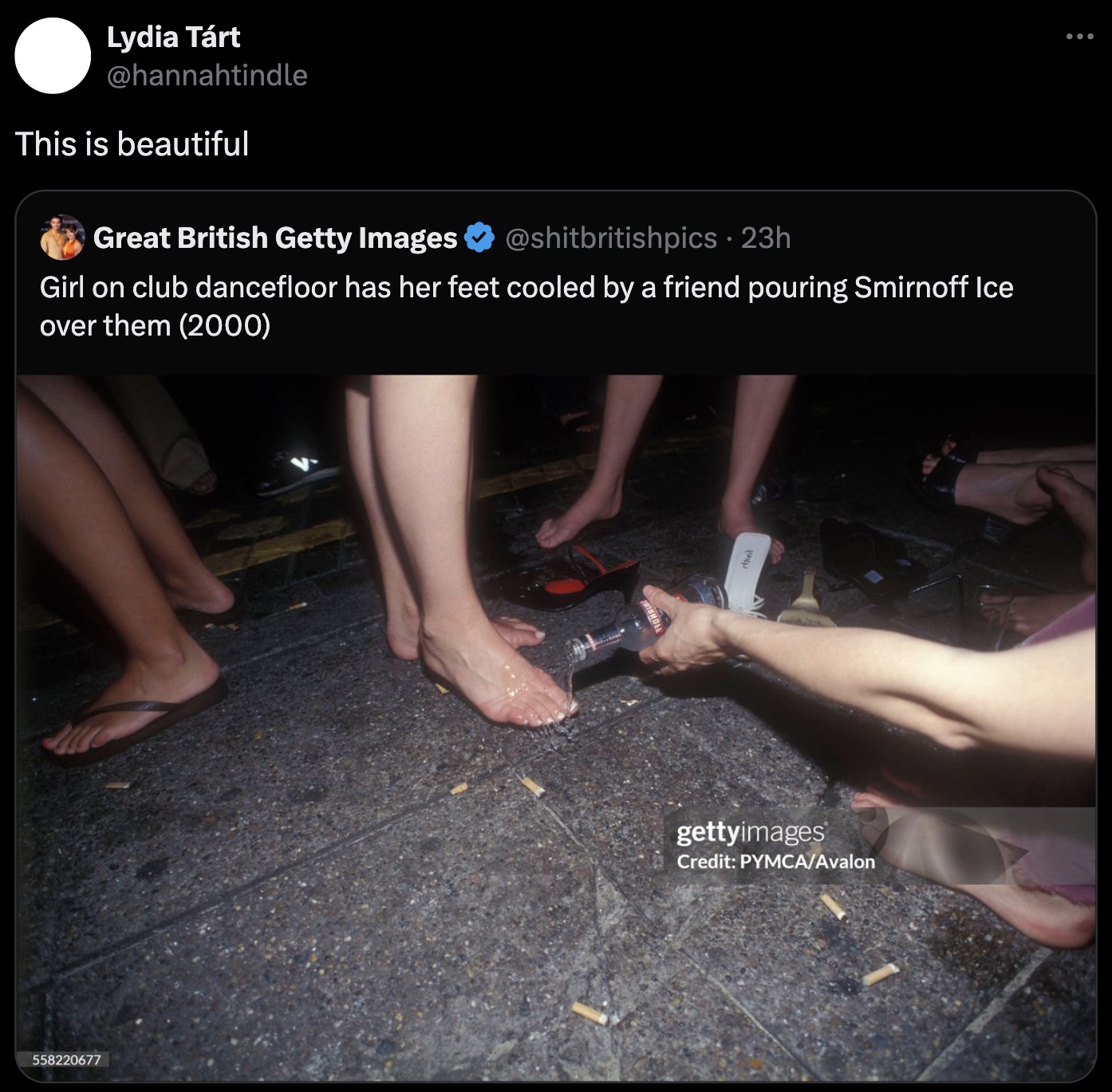 photo caption - 558220677 Lydia Trt This is beautiful Great British Getty Images 23h Girl on club dancefloor has her feet cooled by a friend pouring Smirnoff Ice over them 2000 gettyimages Credit PymcaAvalon